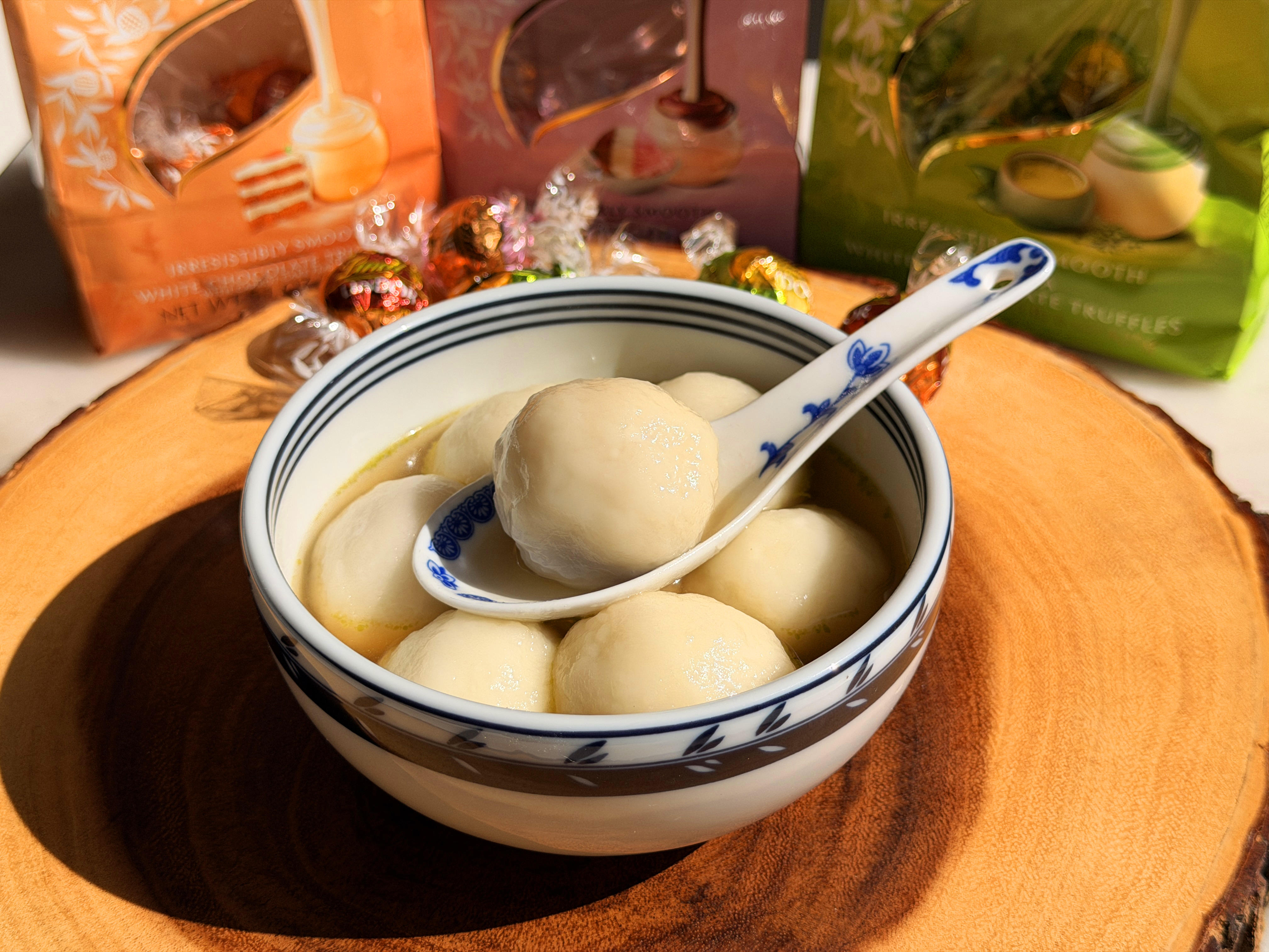 A whole chocolate-filled tang yuan on a spoon